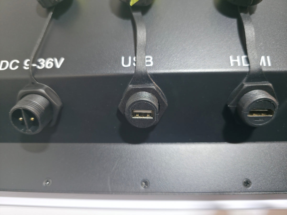 Close-up HDK Marine Display showing three input ports: a DC 5-36V connector, a USB connector, and an HDMI connector.